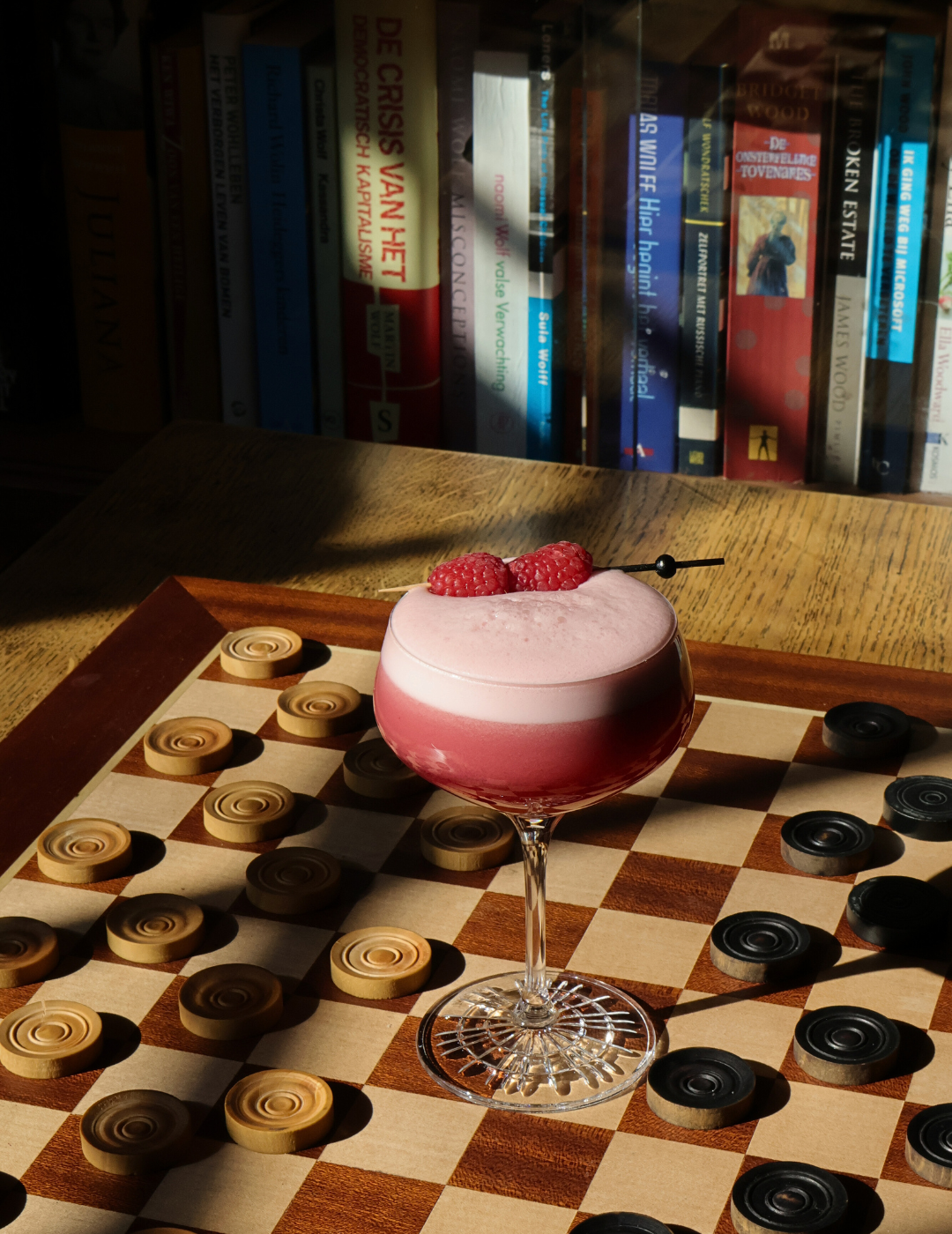 Creative cocktail served on a checkerboard in the library bar at the ambassade hotel, amsterdam.