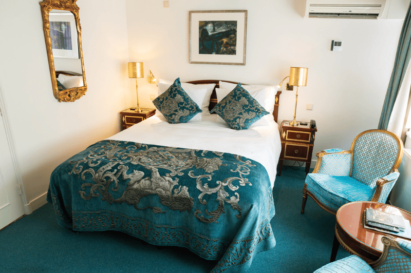 Classic deluxe room at the ambassade hotel in amsterdam with elegant furnishings and canal view.