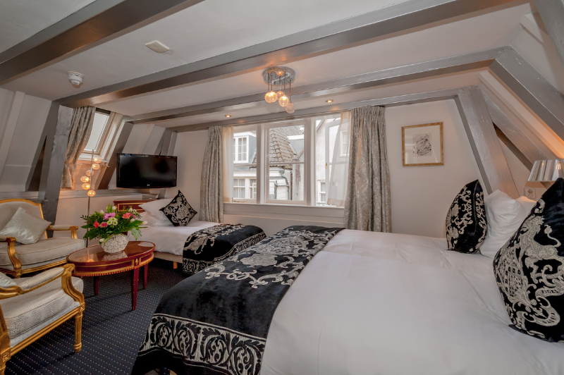 Comfortable triple room for three guests at the ambassade hotel in amsterdam with stylish decor and ample space.