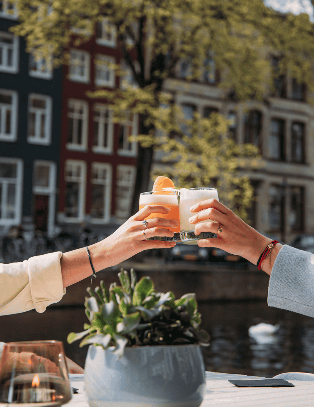 Guests raising their glasses for a toast on the terrace at the ambassade hotel.
