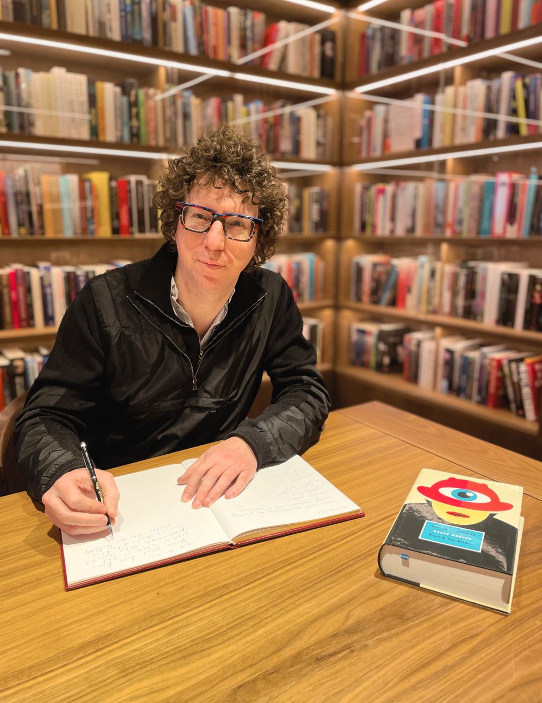 Author arnon grunberg signing his book at the ambassade hotel for the hotel library.