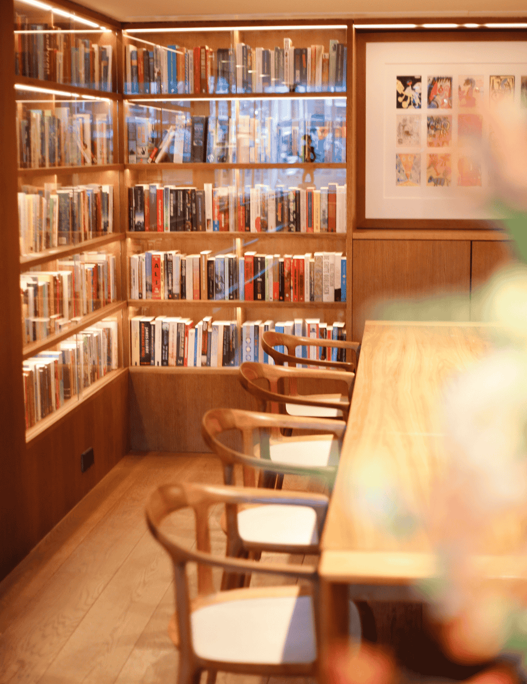 The library lounge at the ambassade hotel with books, art, and elegant seating.