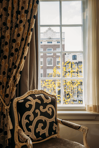 Canal view room at the ambassade hotel in amsterdam with classic decor.