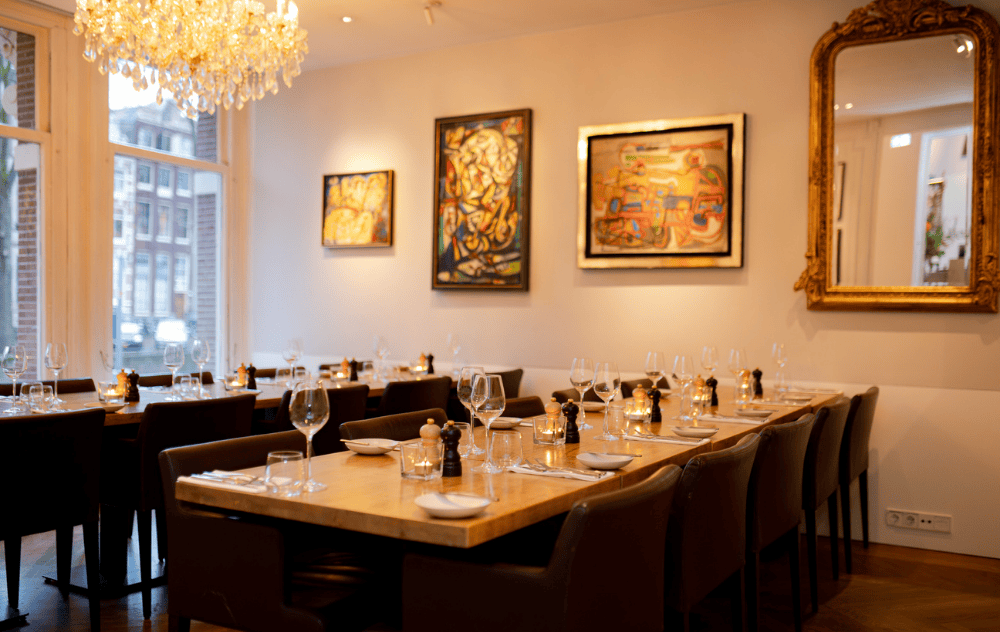 Alechinsky lounge at brasserie ambassade in amsterdam, set up for an elegant private dining experience surrounded by modern art.