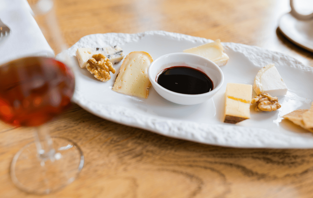 Cheese platter served at brasserie ambassade in amsterdam, featuring a selection of fine cheeses with accompaniments.