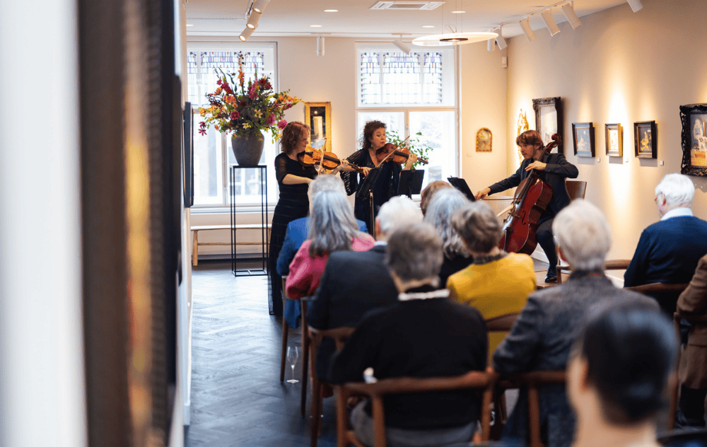 Amsterdam sinfonietta performing a live concert in the ambassade art gallery in amsterdam, surrounded by modern art.