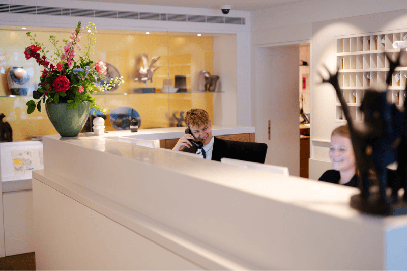 Front office team at the ambassade hotel in amsterdam, ready to assist guests with a warm welcome.