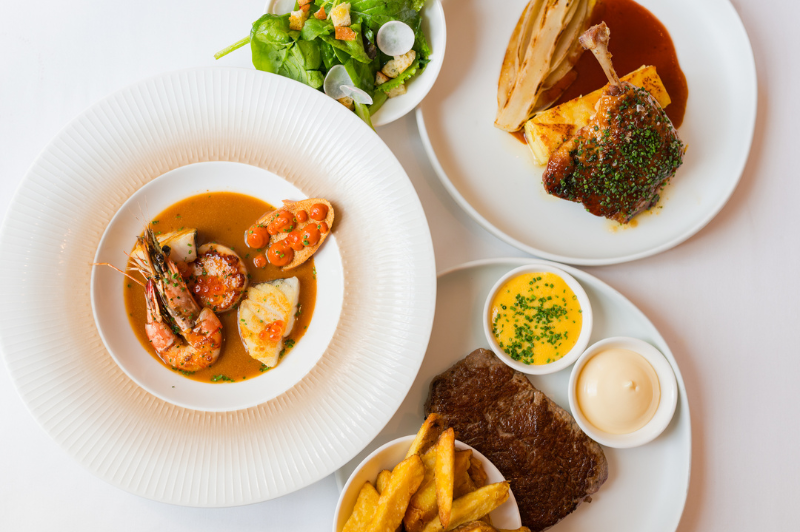 Selection of french cuisine dishes served at brasserie ambassade in amsterdam, showcasing classic flavors and elegant presentation.