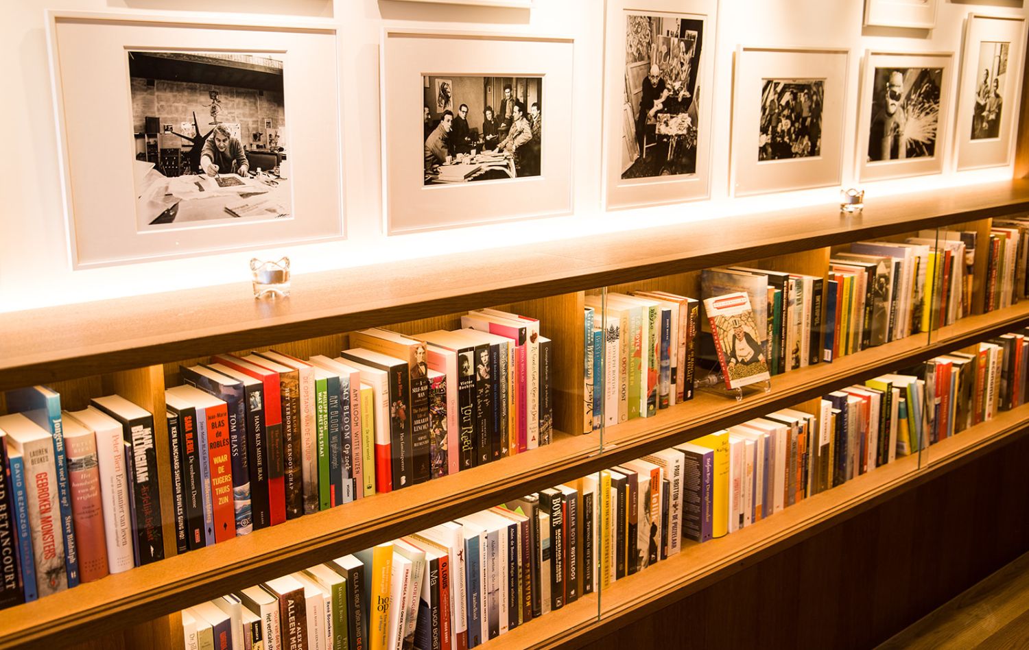Books and framed portraits of cobra artists in the library bar at the ambassade hotel in amsterdam.