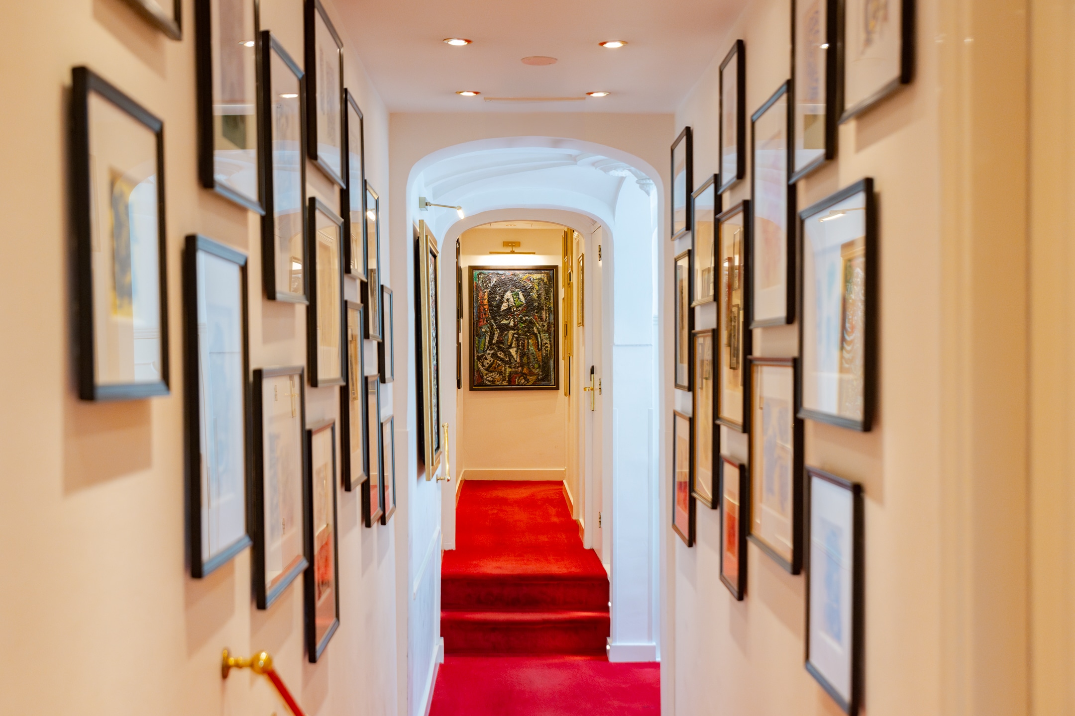 First floor corridor at the ambassade hotel featuring cobra artworks by wolvecamp on the walls.