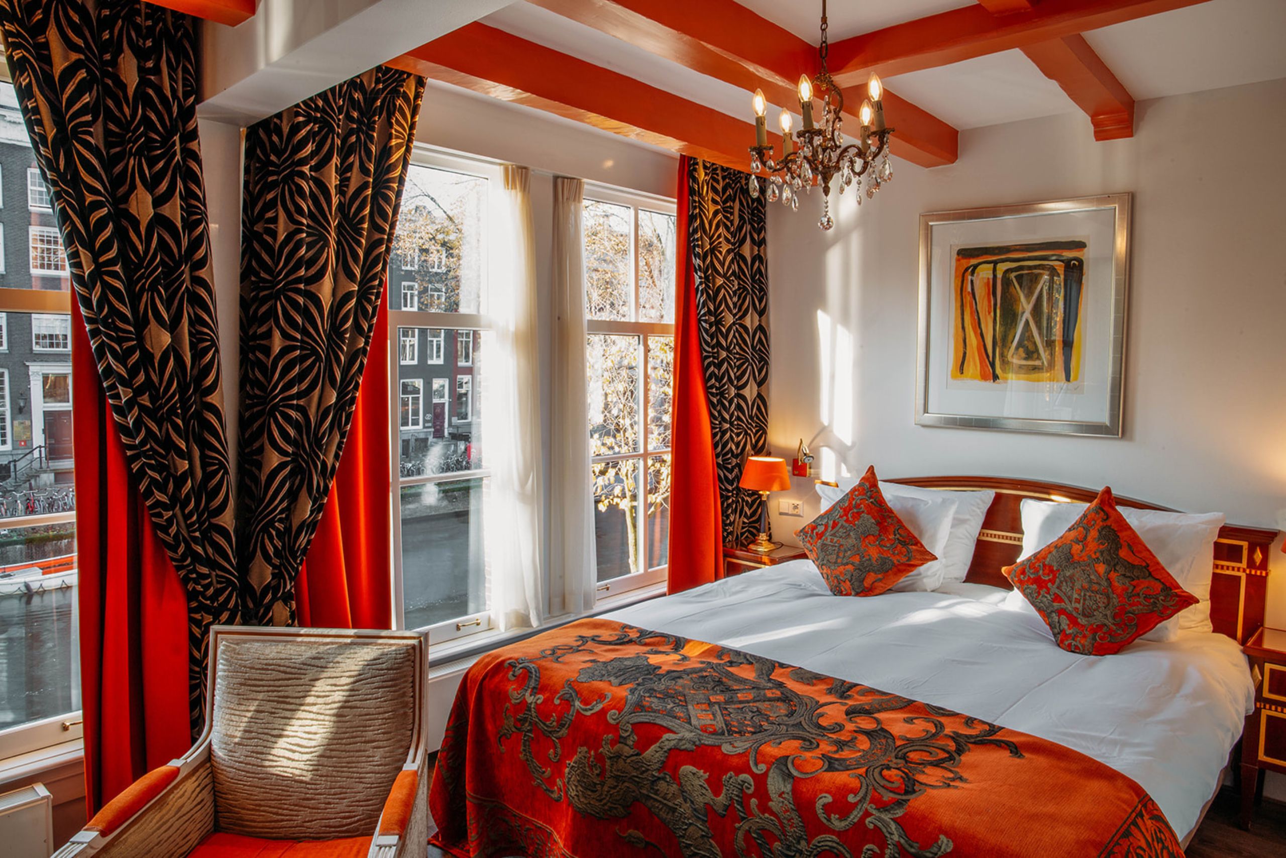 Spacious superior deluxe room with canal view, king-size or twin beds, and luxurious bathroom at the ambassade hotel.