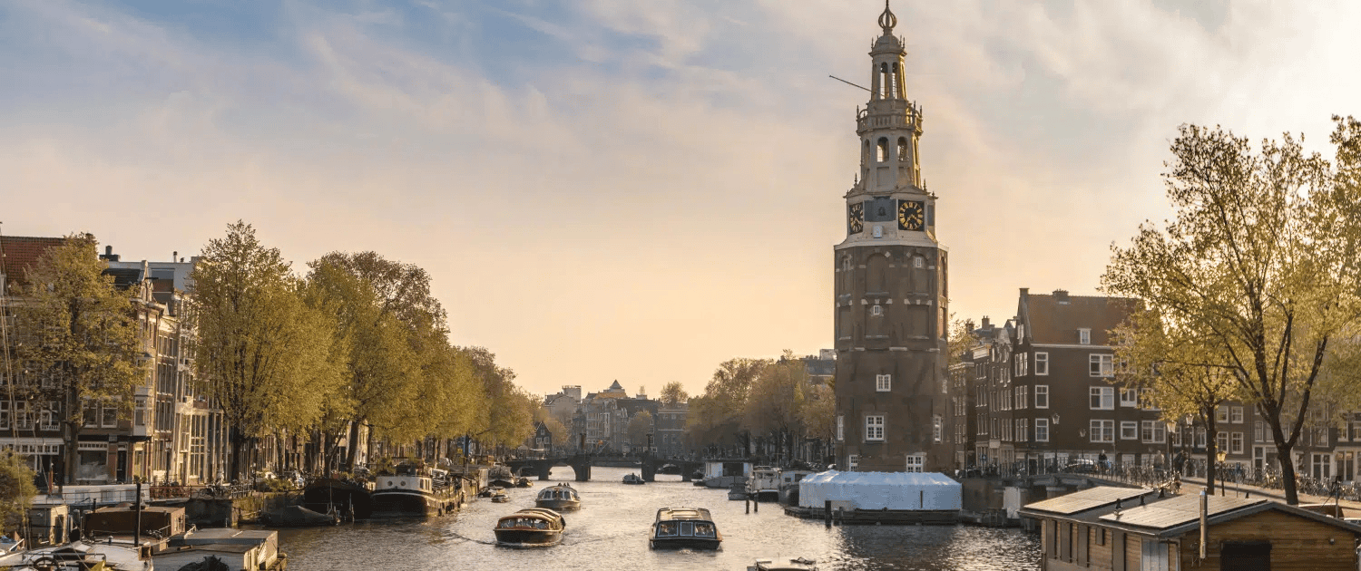 Photo pittoresque des canaux d’Amsterdam avec des bâtiments historiques.